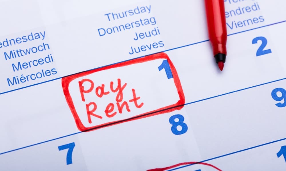 Blue calendar number with red letters spelling “pay rent” circled in red, illustrating our post on rent collection methods.